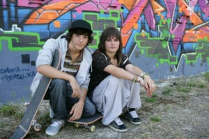 TEENS ON SKATEBOARD LOOKING SERIOUS